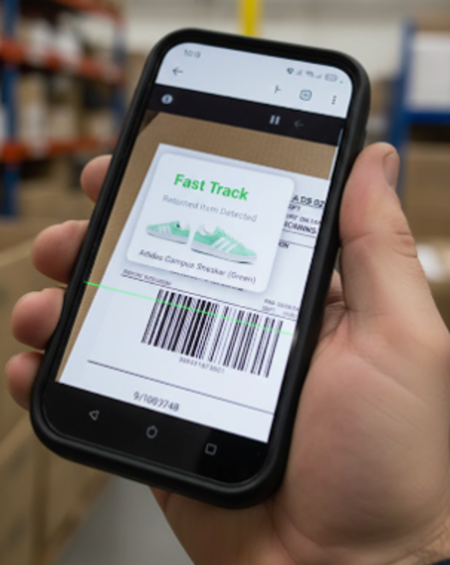 Operator scanning a returned item at the dock with the Returniverse handheld app. Fast Track instantly detects an Adidas Campus sneaker